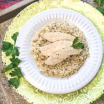 sliced chicken breast on bed of rice in serving dish