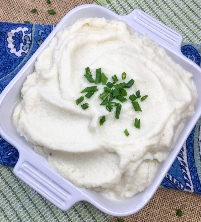 low histamine cauliflower mash in serving dish with chives garnish