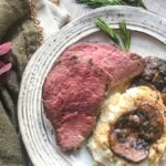 low histamine rosemary garlic tenderloin medium rare on a plate next to mashed cauliflower and mushrooms