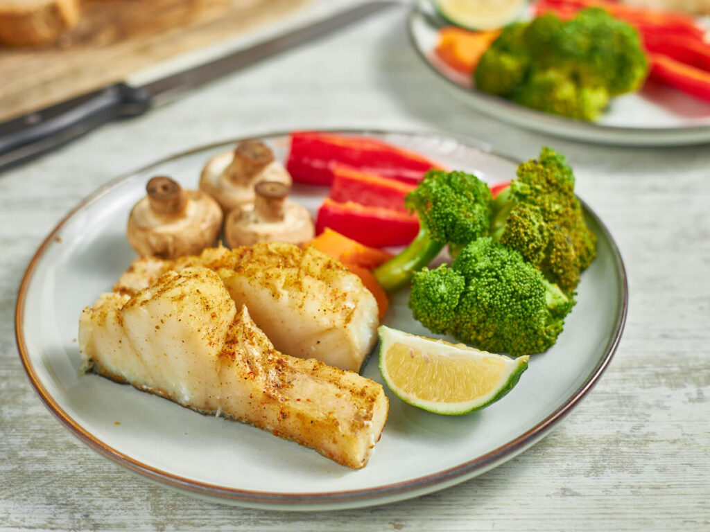 steamed cod with veggies on plate